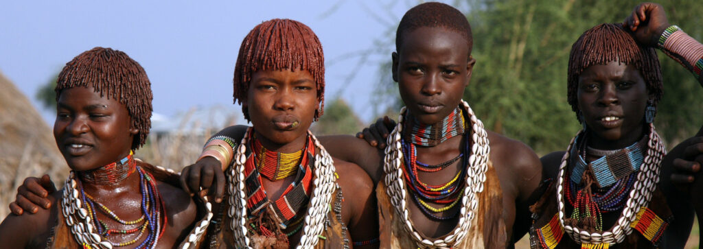 hamar girls hugging with jewelleries sea shells South Omo valley 15+ indigenous tribes