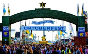 Munich day tours: green arched Welcome to Oktoberfest gate to the Theresiewise